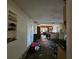 Hallway with decorative shelving leading to kitchen and living areas, ready for your personal touch and updates at 32348 Marchmont Cir, Dade City, FL 33523