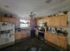 Traditional kitchen with wood cabinets, black appliances, and a ceiling fan at 32348 Marchmont Cir, Dade City, FL 33523