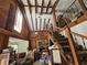 Spacious living room with high ceilings, wooden beams, and a cozy brick fireplace at 32348 Marchmont Cir, Dade City, FL 33523