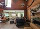 View of the Living Room featuring a ceiling fan, brick fireplace, and lots of potential at 32348 Marchmont Cir, Dade City, FL 33523