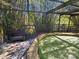 View of the unique artificial pool in a screened enclosure with a natural bamboo forest surrounding the area at 32348 Marchmont Cir, Dade City, FL 33523