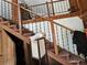 Carpeted staircase with dark wrought iron railing, leading to the upper level at 32348 Marchmont Cir, Dade City, FL 33523