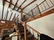 Elegant staircase with wrought iron railing and wooden banister leading to the upper level at 32348 Marchmont Cir, Dade City, FL 33523