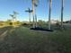 Lush backyard landscaping featuring palm trees and views of the water at 3338 Fernleaf Dr, Hernando Beach, FL 34607