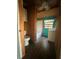 Compact, wood-paneled bathroom with a toilet, tub, and vanity with turquoise accent wall at 3338 Fernleaf Dr, Hernando Beach, FL 34607