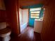 Compact bathroom featuring a tub and vanity with a turquoise accent wall at 3338 Fernleaf Dr, Hernando Beach, FL 34607
