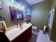 Bathroom featuring a vanity, toilet and stylish decor at 3338 Fernleaf Dr, Hernando Beach, FL 34607