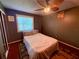 Bright bedroom featuring a window, ceiling fan and accent art at 3338 Fernleaf Dr, Hernando Beach, FL 34607