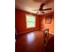 Bedroom featuring laminate flooring, a ceiling fan, a window with a view, and a small painting at 3338 Fernleaf Dr, Hernando Beach, FL 34607