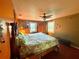 Well-lit bedroom featuring a leafy comforter, ceiling fan and two windows at 3338 Fernleaf Dr, Hernando Beach, FL 34607