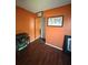 Bedroom featuring laminate flooring, closet storage, an orange wall, and a small writing desk at 3338 Fernleaf Dr, Hernando Beach, FL 34607