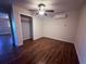Cozy bedroom with new wood-look flooring, ceiling fan, and convenient closet space at 3338 Fernleaf Dr, Hernando Beach, FL 34607