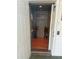 Residential elevator decorated with beach-themed decor and wood flooring at 3338 Fernleaf Dr, Hernando Beach, FL 34607