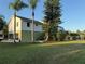 Two-story home with light siding, mature trees, and lawn at 3338 Fernleaf Dr, Hernando Beach, FL 34607