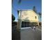 Two-story home with ground floor screened garage and white siding at 3338 Fernleaf Dr, Hernando Beach, FL 34607