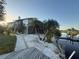 Exterior of the home features lakeside views, a deck, and a screened-in pool at 3338 Fernleaf Dr, Hernando Beach, FL 34607