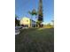 Two-story home with screened garage, stairway, lawn, and palm trees at 3338 Fernleaf Dr, Hernando Beach, FL 34607