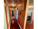 Hallway featuring stylish decor, stainless steel refrigerator, and access to multiple rooms at 3338 Fernleaf Dr, Hernando Beach, FL 34607