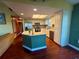 Bright kitchen with stainless steel appliances, center island, and warm wood flooring perfect for cooking and entertaining at 3338 Fernleaf Dr, Hernando Beach, FL 34607