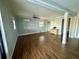 Spacious living room with ceiling fan and wood-look flooring throughout the home at 3338 Fernleaf Dr, Hernando Beach, FL 34607