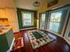 Bright living area with hardwood floors, tropical rug and a water view at 3338 Fernleaf Dr, Hernando Beach, FL 34607