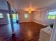 Inviting living area enhanced by wood-look floors, a ceiling fan, and plenty of natural light at 3338 Fernleaf Dr, Hernando Beach, FL 34607