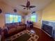 Cozy living room featuring a fireplace, comfortable sofa, and inviting decor with vaulted ceiling at 3338 Fernleaf Dr, Hernando Beach, FL 34607