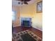 Living room with fire place, ceiling fan, and a tropical themed rug at 3338 Fernleaf Dr, Hernando Beach, FL 34607
