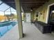 Spacious covered patio with pool access and water views provides a perfect setting for outdoor relaxation and entertainment at 3338 Fernleaf Dr, Hernando Beach, FL 34607