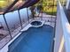 A screened-in pool and hot tub overlooking the canal at 3338 Fernleaf Dr, Hernando Beach, FL 34607