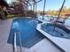 Inviting screened-in pool and spa overlooking the water creates a perfect space for outdoor relaxation and recreation at 3338 Fernleaf Dr, Hernando Beach, FL 34607