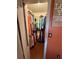 Walk-in closet with a variety of clothing and a storage sign on the wall at 3338 Fernleaf Dr, Hernando Beach, FL 34607