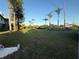 Large grassy yard with palm trees, shrubbery and view of the two story home at 3338 Fernleaf Dr, Hernando Beach, FL 34607