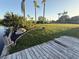 Well-manicured lawn, with mulch beds, shrubbery and a view of the canal at 3338 Fernleaf Dr, Hernando Beach, FL 34607