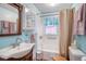 Charming bathroom features bright blue walls and tub with shower at 3405 E Diana St, Tampa, FL 33610
