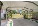 Large, open carport featuring a concrete slab base and metal frame, providing covered parking at 3405 E Diana St, Tampa, FL 33610