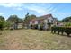 Exterior view of a charming house with a carport, well-maintained landscaping, and a spacious front yard at 3405 E Diana St, Tampa, FL 33610