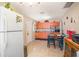 Traditional kitchen with tile flooring, white appliances, and cozy dining area at 3405 E Diana St, Tampa, FL 33610
