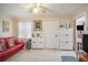 Living room displaying neutral walls, red leather sofa, and ceiling fan at 3405 E Diana St, Tampa, FL 33610