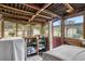 Enclosed patio with wooden beams, storage shelving, and outdoor views through screened windows at 3405 E Diana St, Tampa, FL 33610