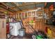 Interior view of shed with wooden walls, shelving, tools, ladder, lawn mower and laundry machines at 3405 E Diana St, Tampa, FL 33610
