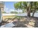 Large backyard with mature tree and a white vinyl privacy fence at 3445 Pinehurst Dr, Holiday, FL 34691