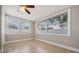This bedroom features natural light from two windows and tile floors at 3445 Pinehurst Dr, Holiday, FL 34691