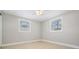 This bedroom features natural light from two windows and tile floors at 3445 Pinehurst Dr, Holiday, FL 34691