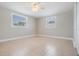 This bedroom features natural light from two windows and tile floors at 3445 Pinehurst Dr, Holiday, FL 34691
