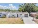Charming single-story home with well-maintained front yard, attached garage, and inviting curb appeal at 3445 Pinehurst Dr, Holiday, FL 34691