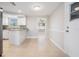Open concept kitchen with granite countertops, white cabinets, tile floors, and adjacent dining area at 3445 Pinehurst Dr, Holiday, FL 34691