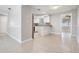 Open concept kitchen with granite countertops, white cabinets, stainless appliances and easy access to other living spaces at 3445 Pinehurst Dr, Holiday, FL 34691