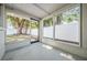 View of screened-in porch with access to the backyard through sliding glass doors at 3445 Pinehurst Dr, Holiday, FL 34691