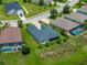 A high aerial shot showcasing the home's backyard, landscaping, and neighborhood at 34652 Heavenly Ln, Dade City, FL 33525
